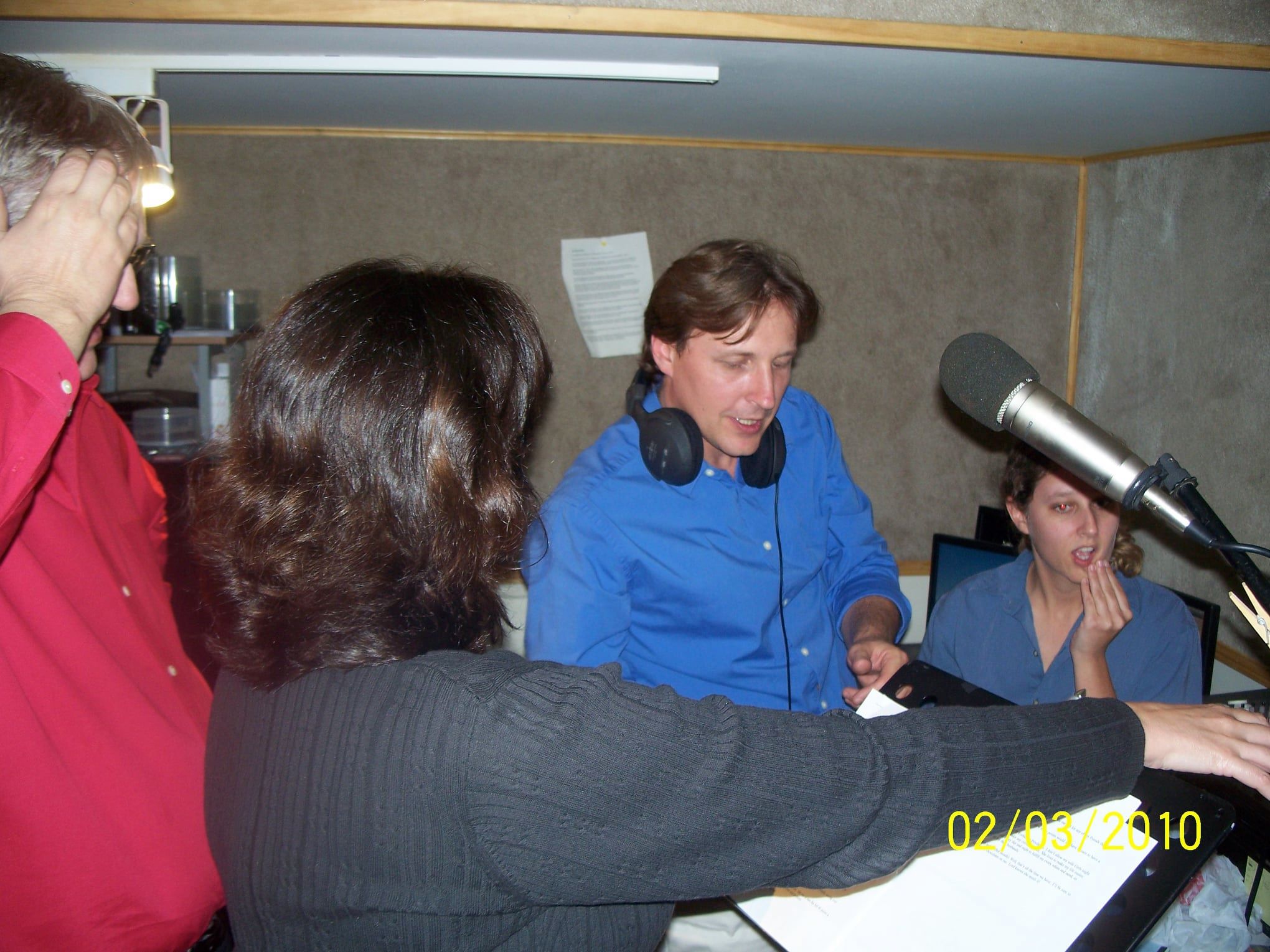 Team reviewing script in studio