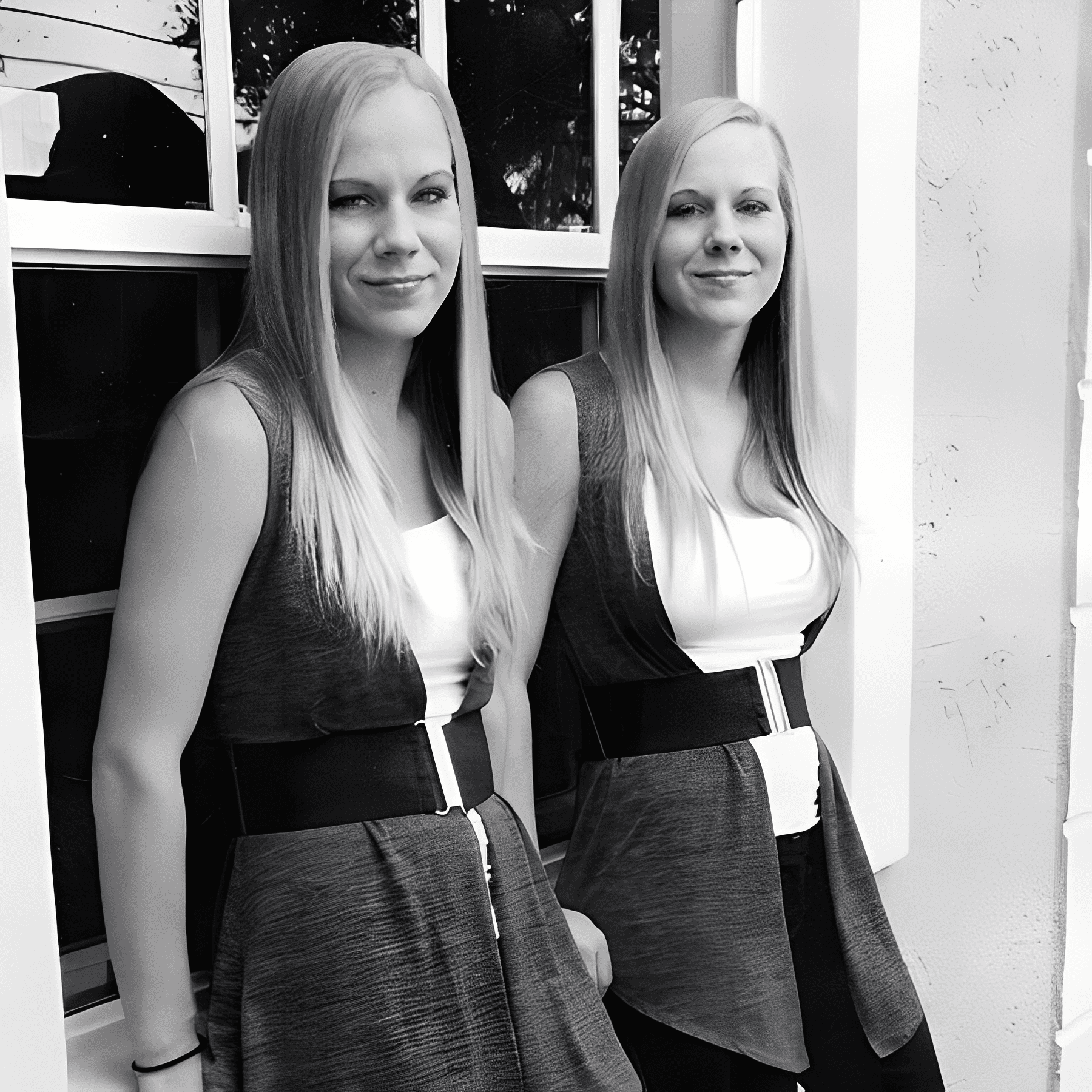 Two women in matching outfits by window