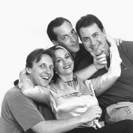 Four adults smiling and posing together