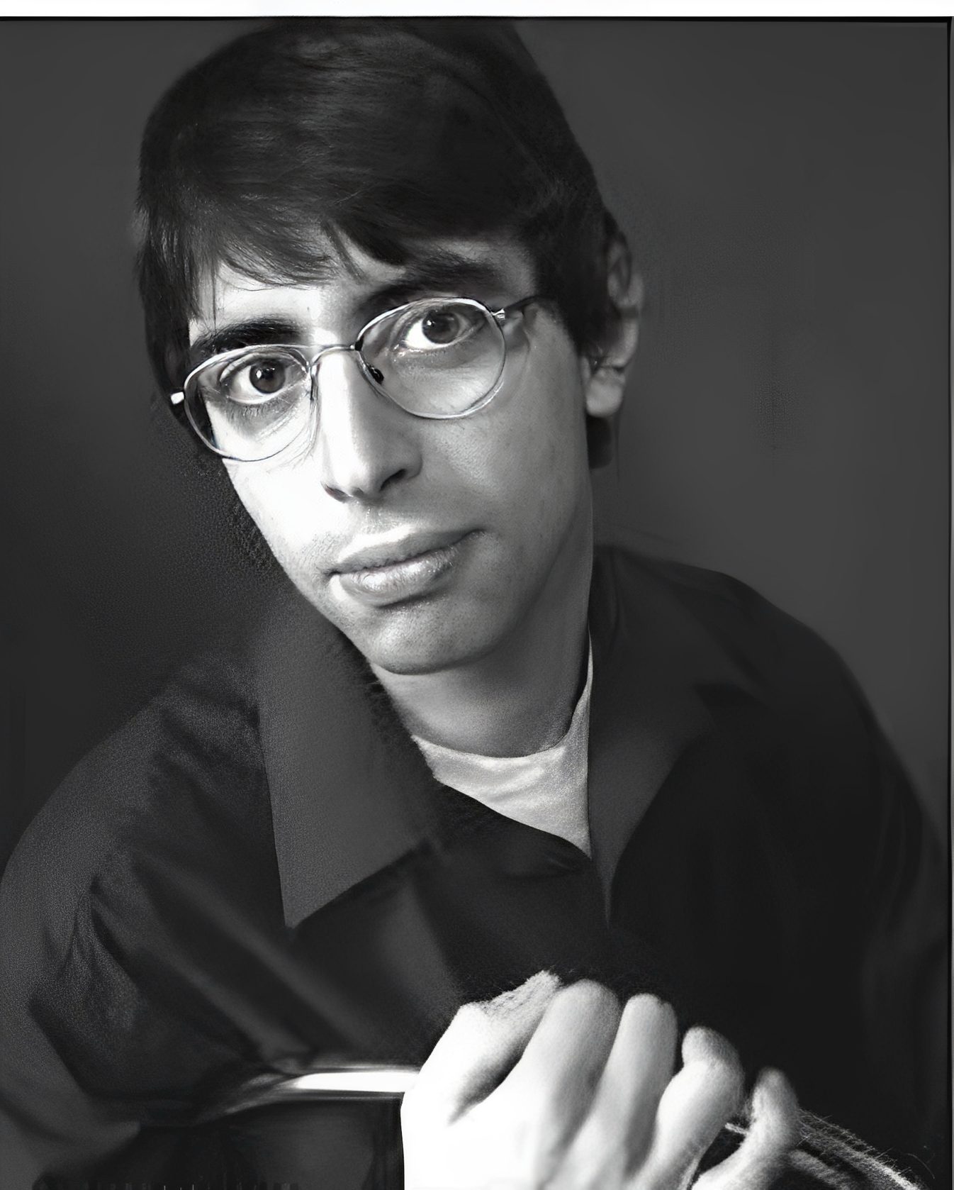 Portrait of person with glasses holding umbrella